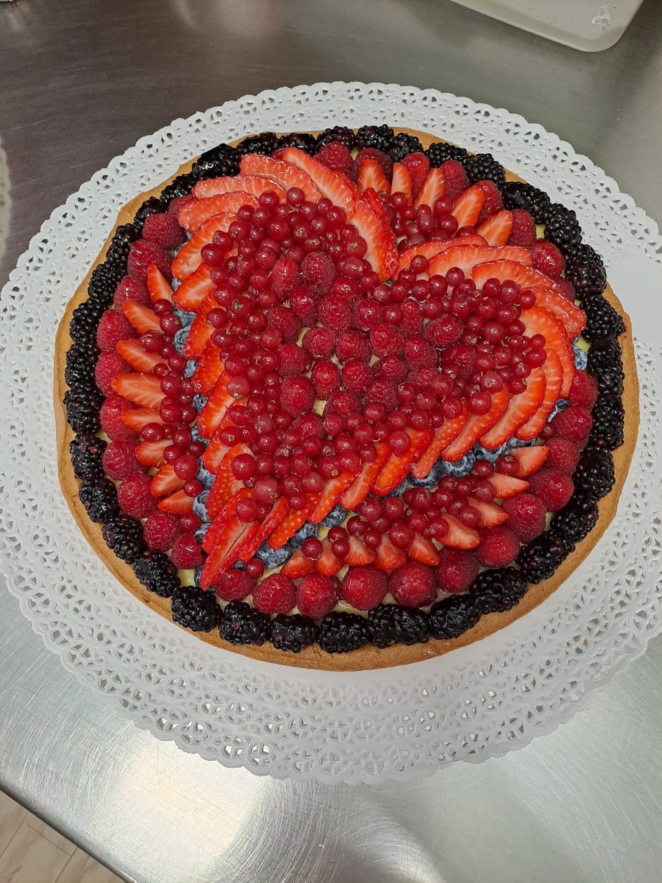 Mixed berry tart with a heart of strawberries, redcurrants and raspberries