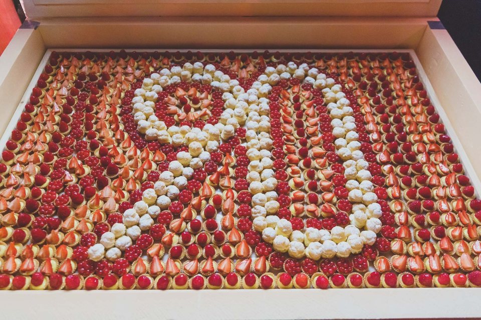 Tray of miniature fruit pastries and choux buns arranged as the number 90