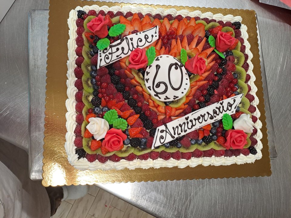 Sixtieth anniversary cake with fresh fruit and decorative roses